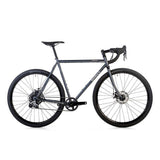 Surly Straggler 1x gravel bike with a steel frame in dark blue, designed for commuting, touring, and gravel riding.