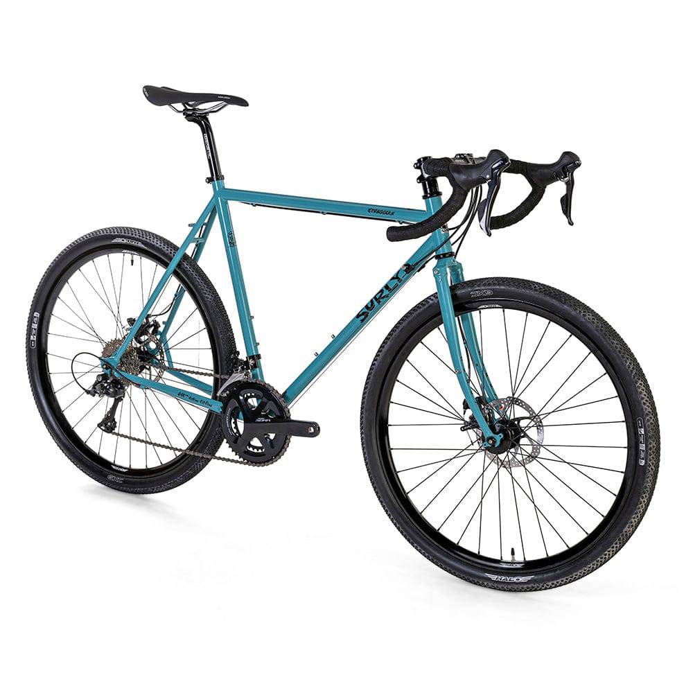 Surly Straggler 650b Sora gravel bike with steel frame, flat handlebars, and knobby tires for touring and commuting.
