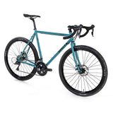 Surly Straggler 650b Sora gravel bike with steel frame, flat handlebars, and knobby tires for touring and commuting.