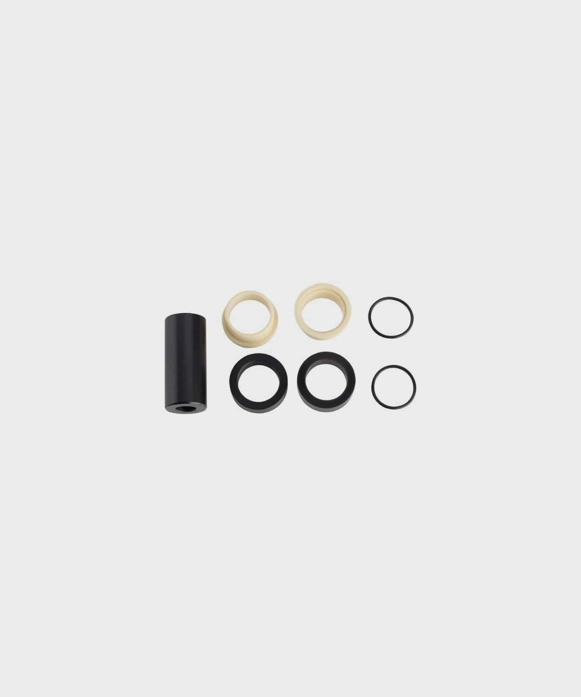 Fox rear shock mount hardware offset spacers with IGUS bushing for bike suspension components, showing close-up of spacers and bushings.