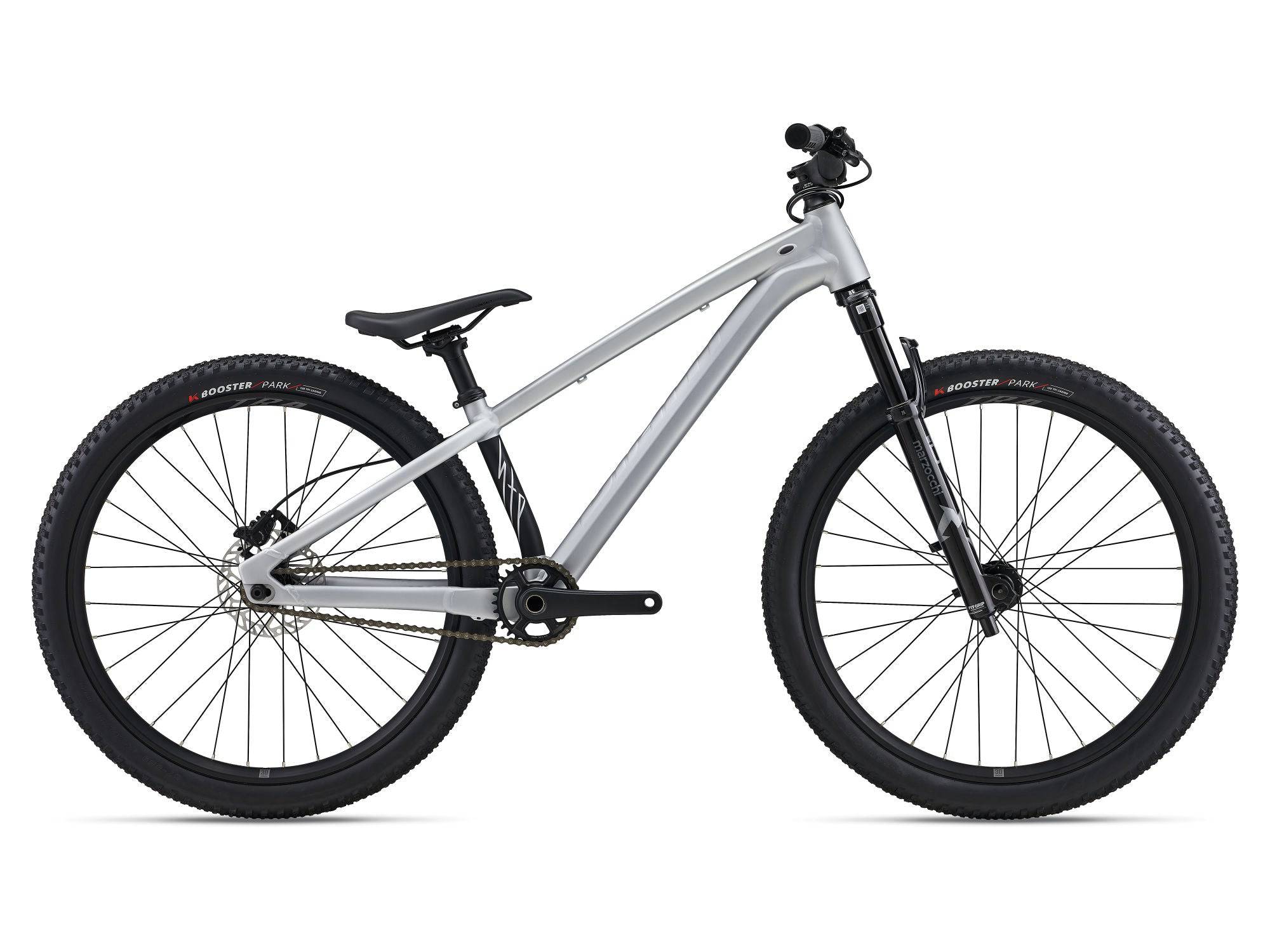 Giant STP 26 kids' bike for dirt jumps and trail riding, featuring a sturdy frame, knobby tires, and suspension for rough terrain.