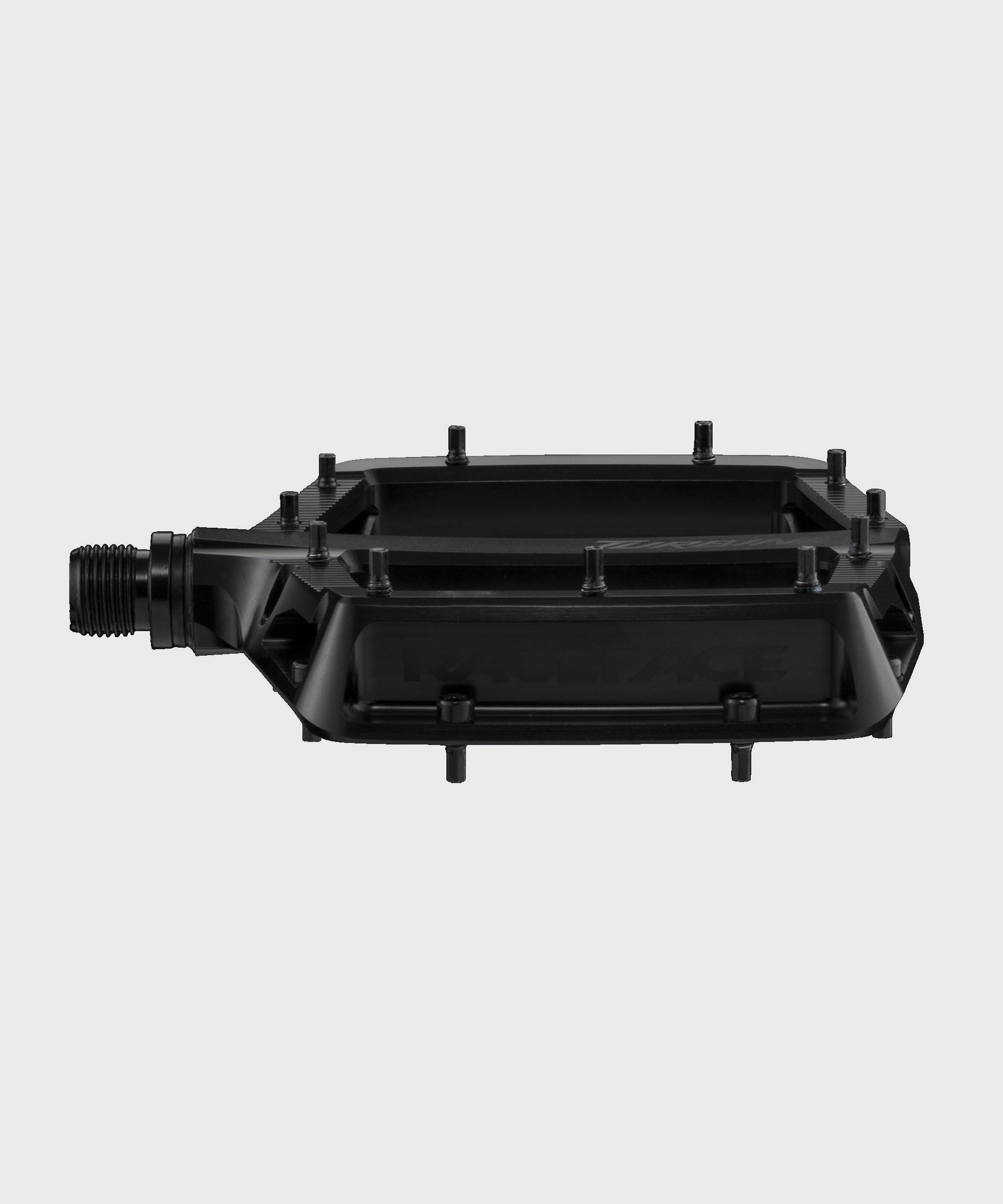 Race Face Turbine mountain bike pedals with adjustable pins for enhanced grip, shown with rugged metal design and clip-in interface.