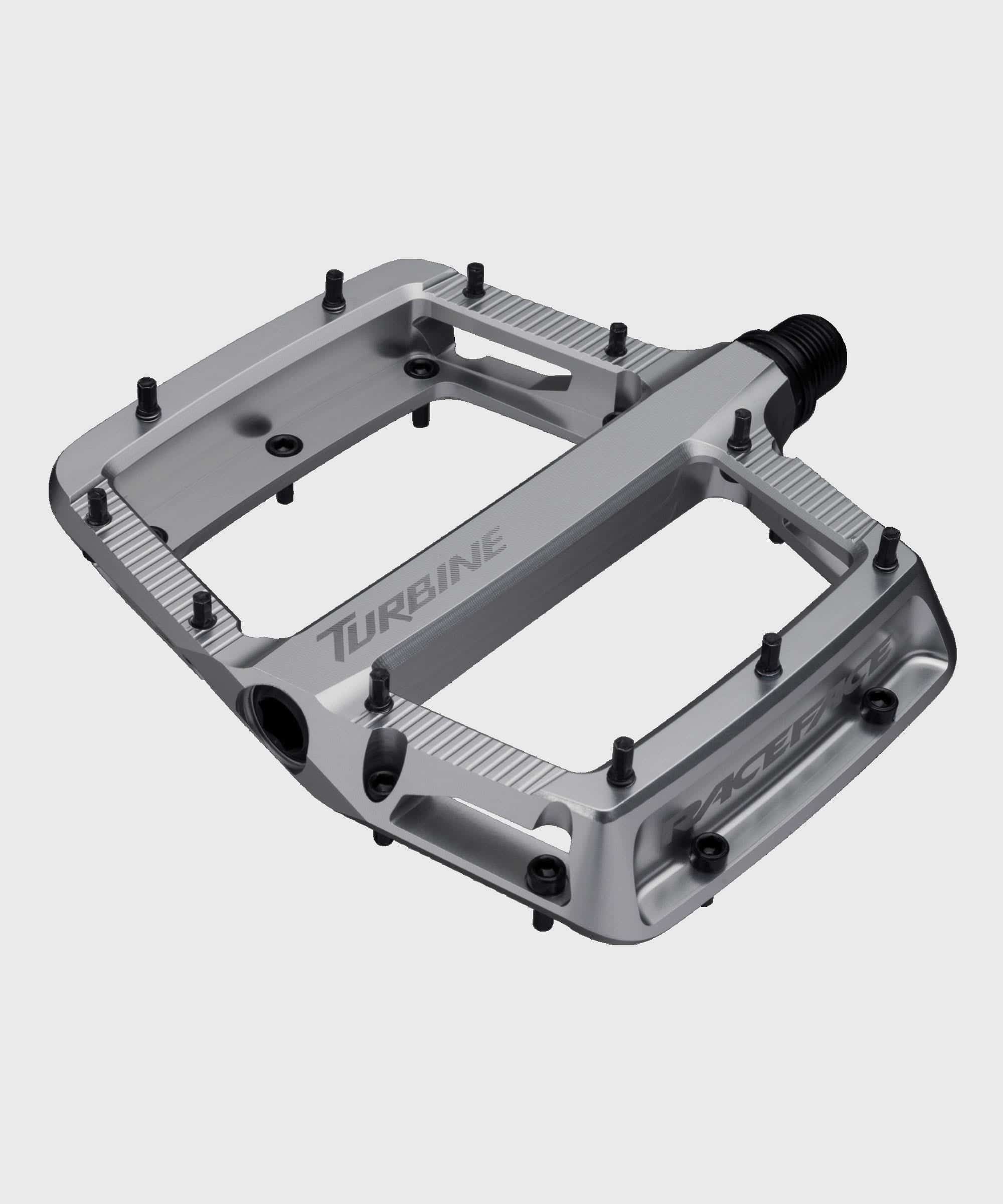Race Face Turbine mountain bike pedals with adjustable pins for maximum grip, shown with textured metal platform and clip-in design.