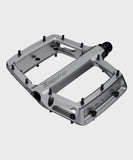 Race Face Turbine mountain bike pedals with adjustable pins for maximum grip, shown with textured metal platform and clip-in design.