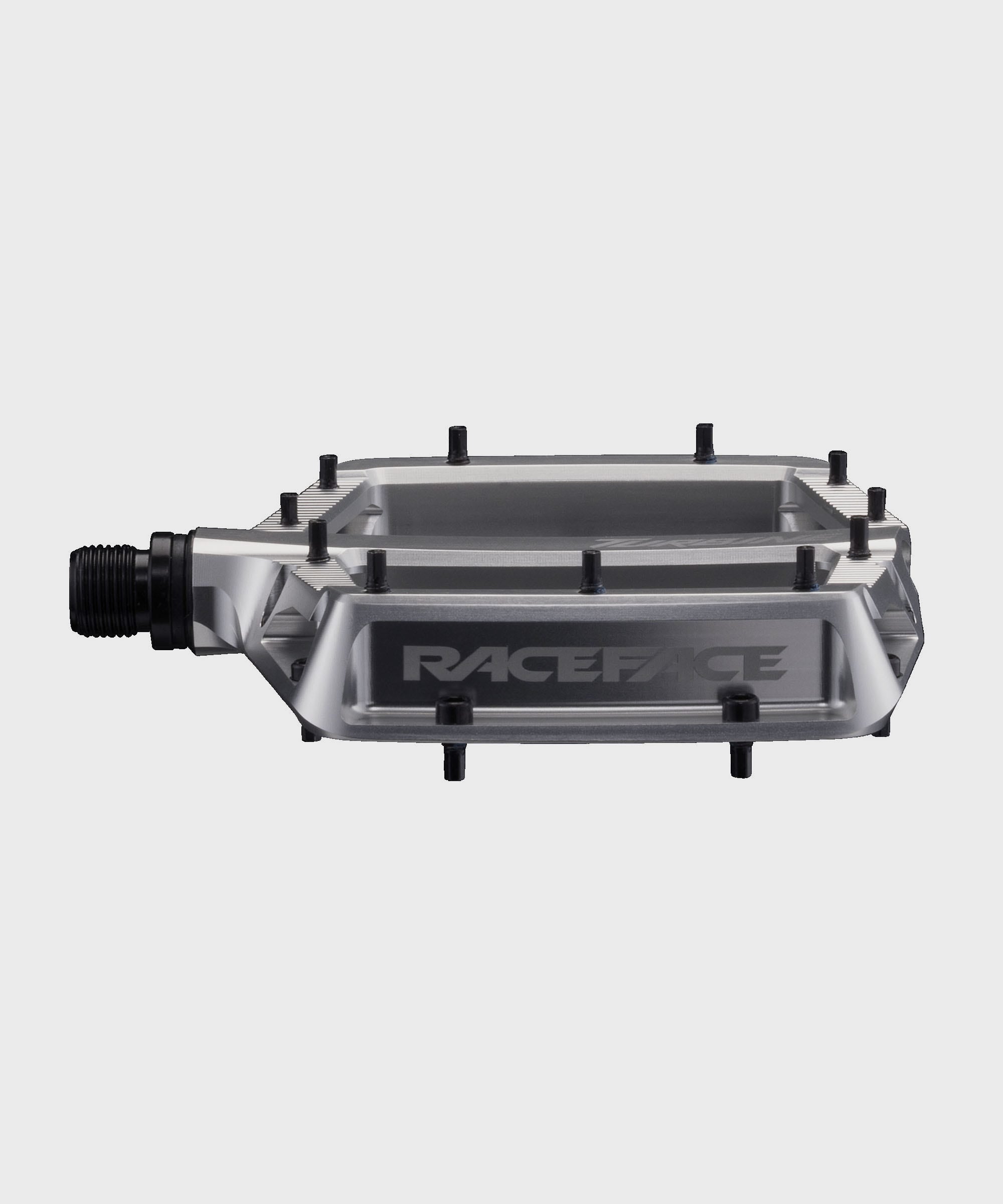 Race Face Turbine mountain bike pedals with adjustable pins for maximum grip, showcasing durable metal construction and pedal platform.