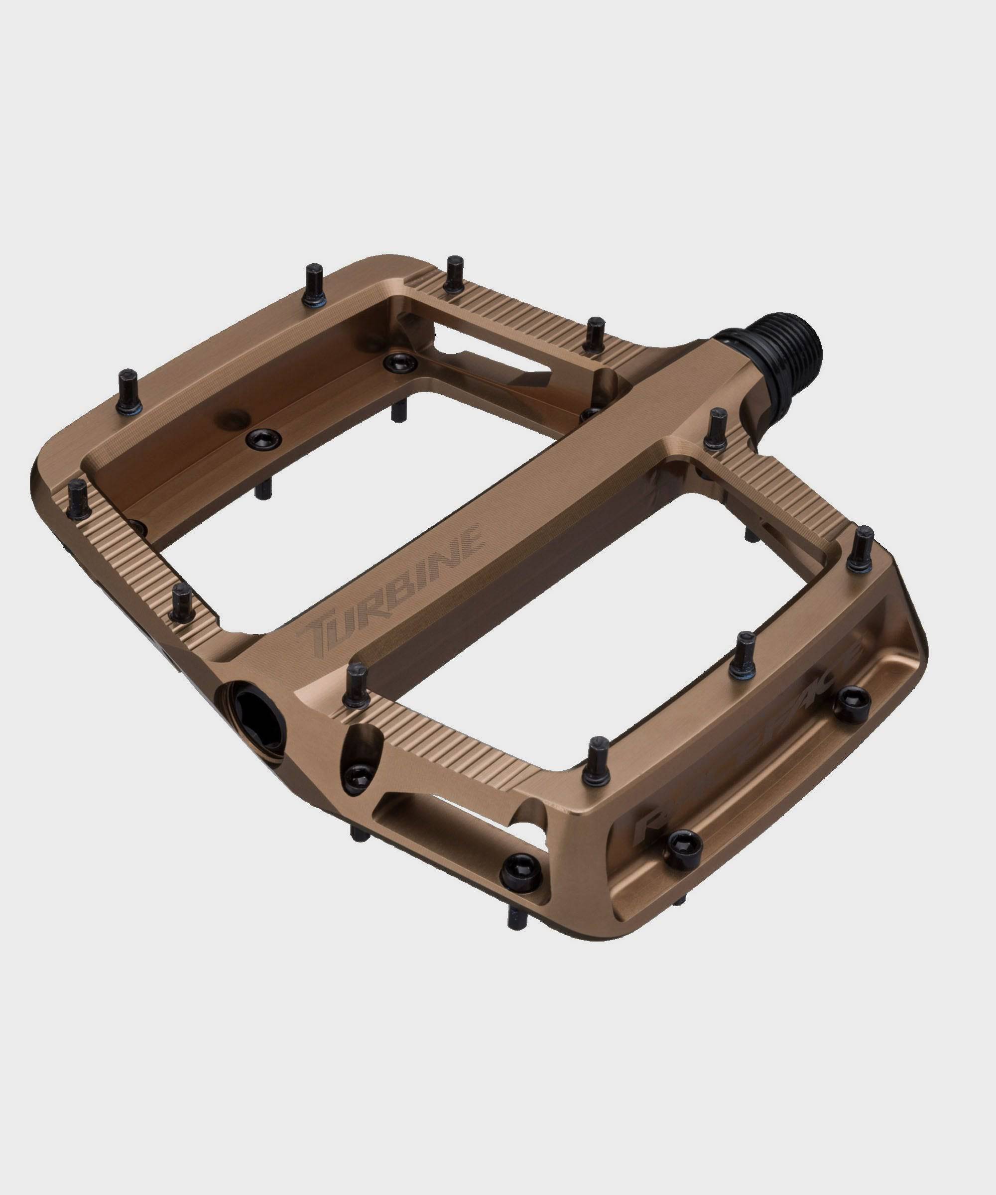 Race Face Turbine mountain bike pedals with adjustable pins for maximum grip, showcasing durable metal construction and textured surface.