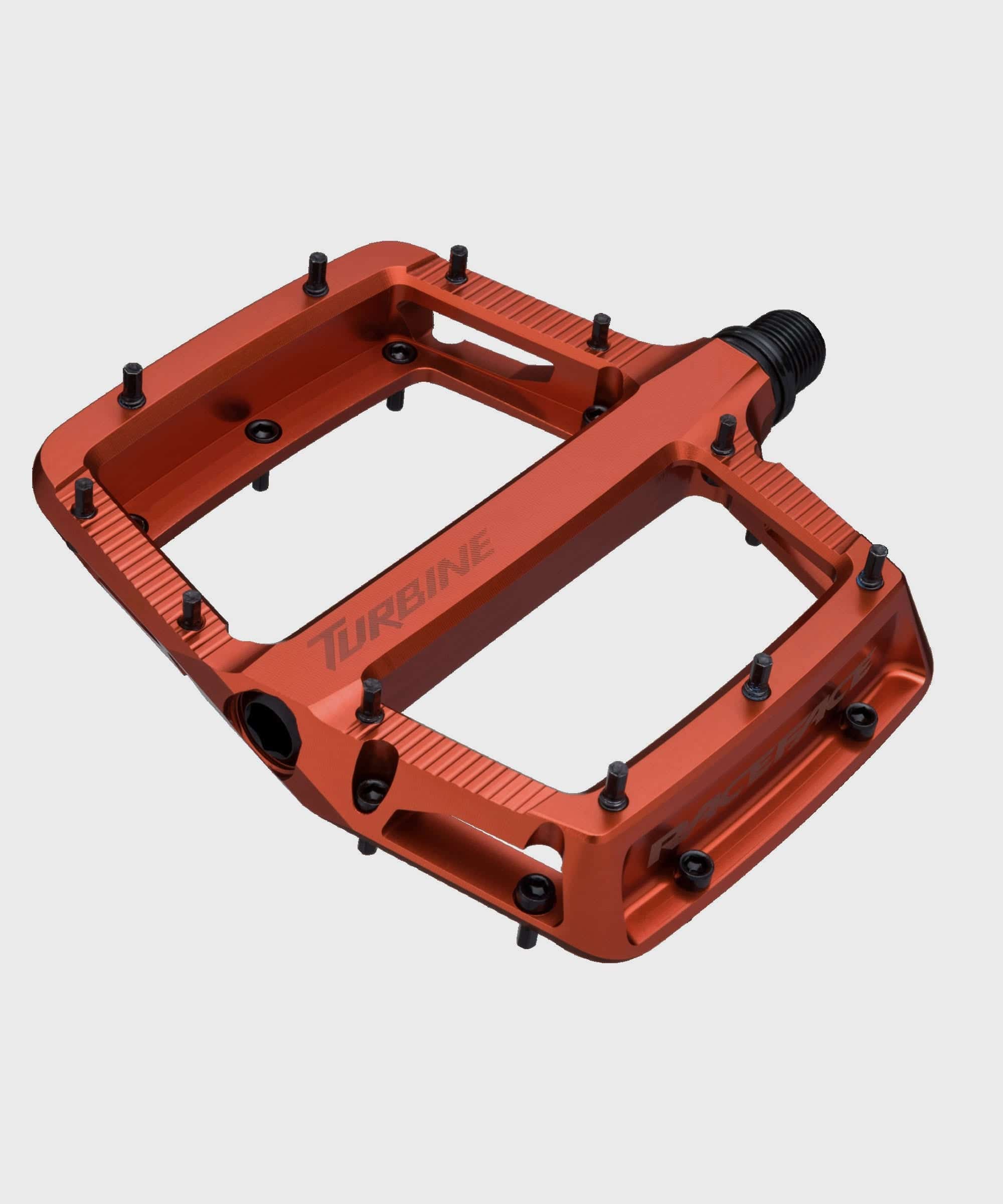 Race Face Turbine mountain bike pedals with adjustable pins for enhanced grip and durability, shown with metal pins and textured surface.