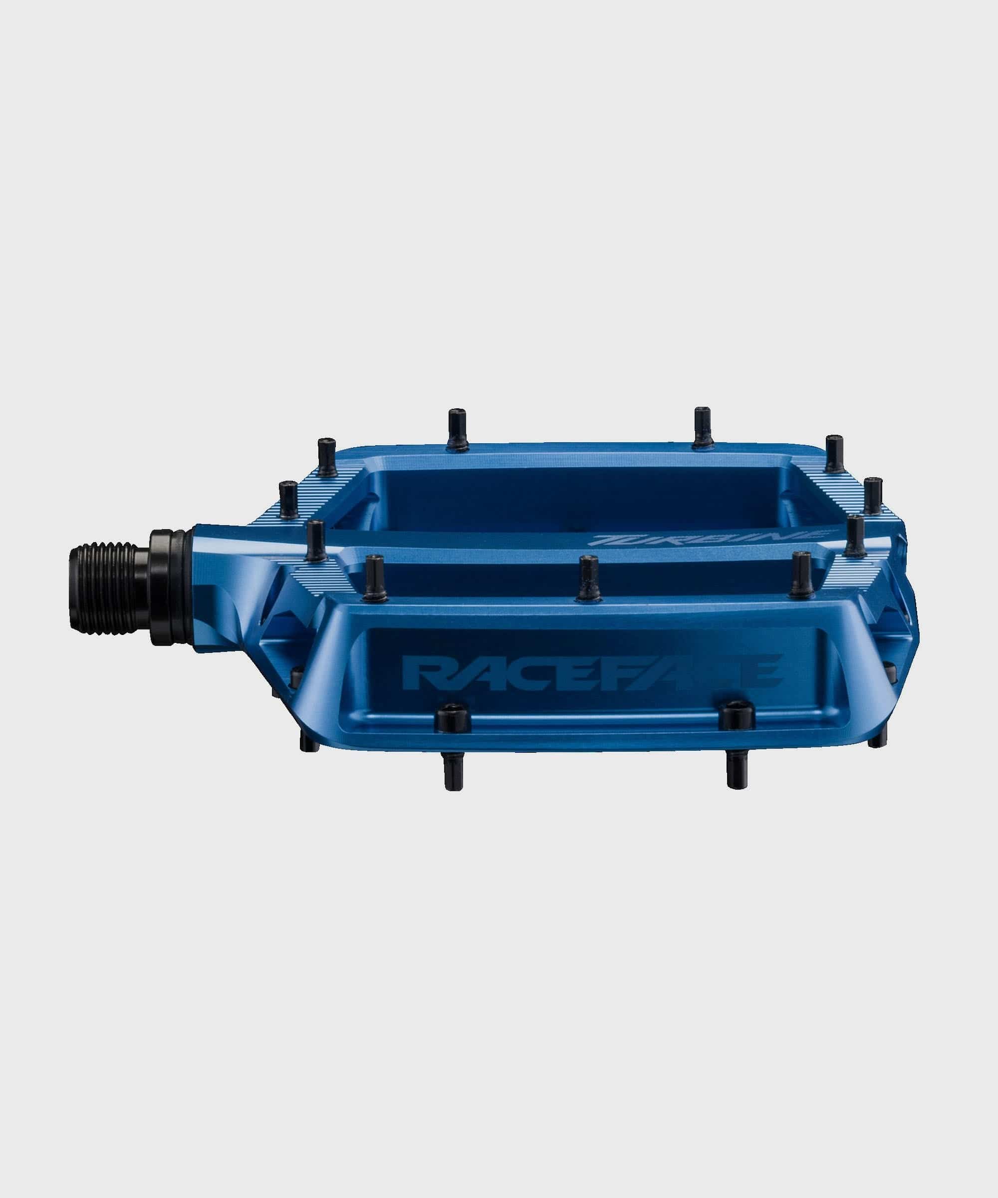Race Face Turbine mountain bike pedals with adjustable pins for enhanced grip, showcasing rugged metal pedals and grip pins.