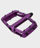 Race Face Turbine mountain bike pedals with adjustable pins for maximum grip, showing black metal pedals with textured surface and pin details.