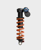 Fox DHX2 Factory mountain bike rear shock with adjustable two-position setting, showcasing its high-performance suspension components.