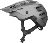 Silver ABUS MODROP mountain bike helmet with adjustable visor and secure fit system, designed for cyclists' safety and comfort.