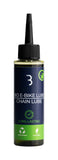 BBB BioEBikeLube 100ml eco-friendly chain lubricant for e-bike chains, suitable for all weather conditions, in a workshop setting.