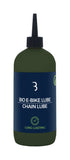 BBB BioEbikeLube 500ml biodegradable chain lubricant for e-bikes, shown in a workshop setting with the product bottle.