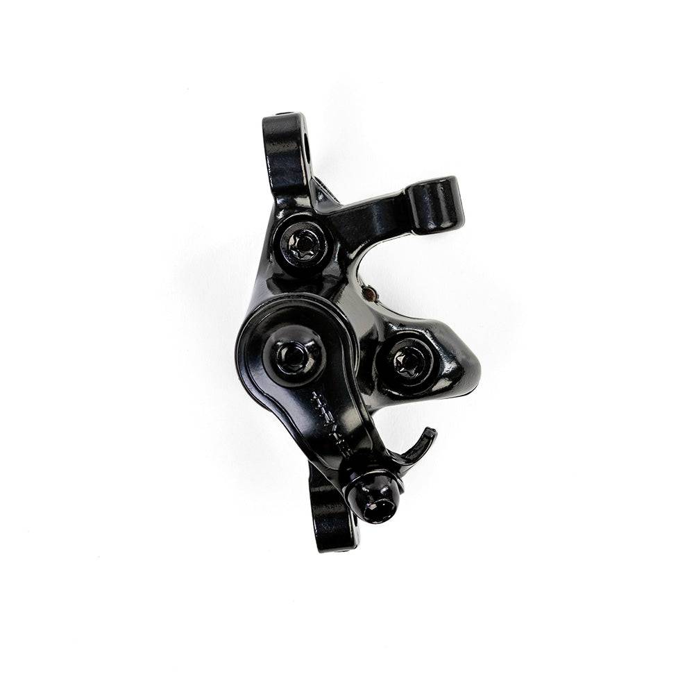 Hayes MX Comp mechanical disc brake for mountain bikes, showing the black brake caliper and rotor, designed for reliable stopping power.