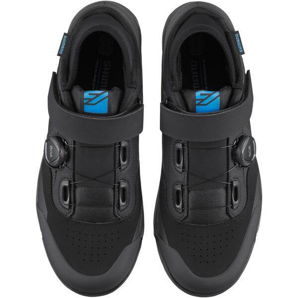 Shimano GE9 gravel shoes with BOA fit system and SPD cleat compatibility, shown in black with secure lacing and sole detail.
