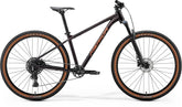 Merida Big Nine 40 mountain bike with black and red frame, durable aluminium hardtail, advanced geometry, and internal cable routing.