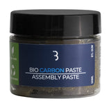 BBB BTL-263W BioCarbonPaste assembly paste for carbon bike components, shown in a 500ml container with workshop tools.