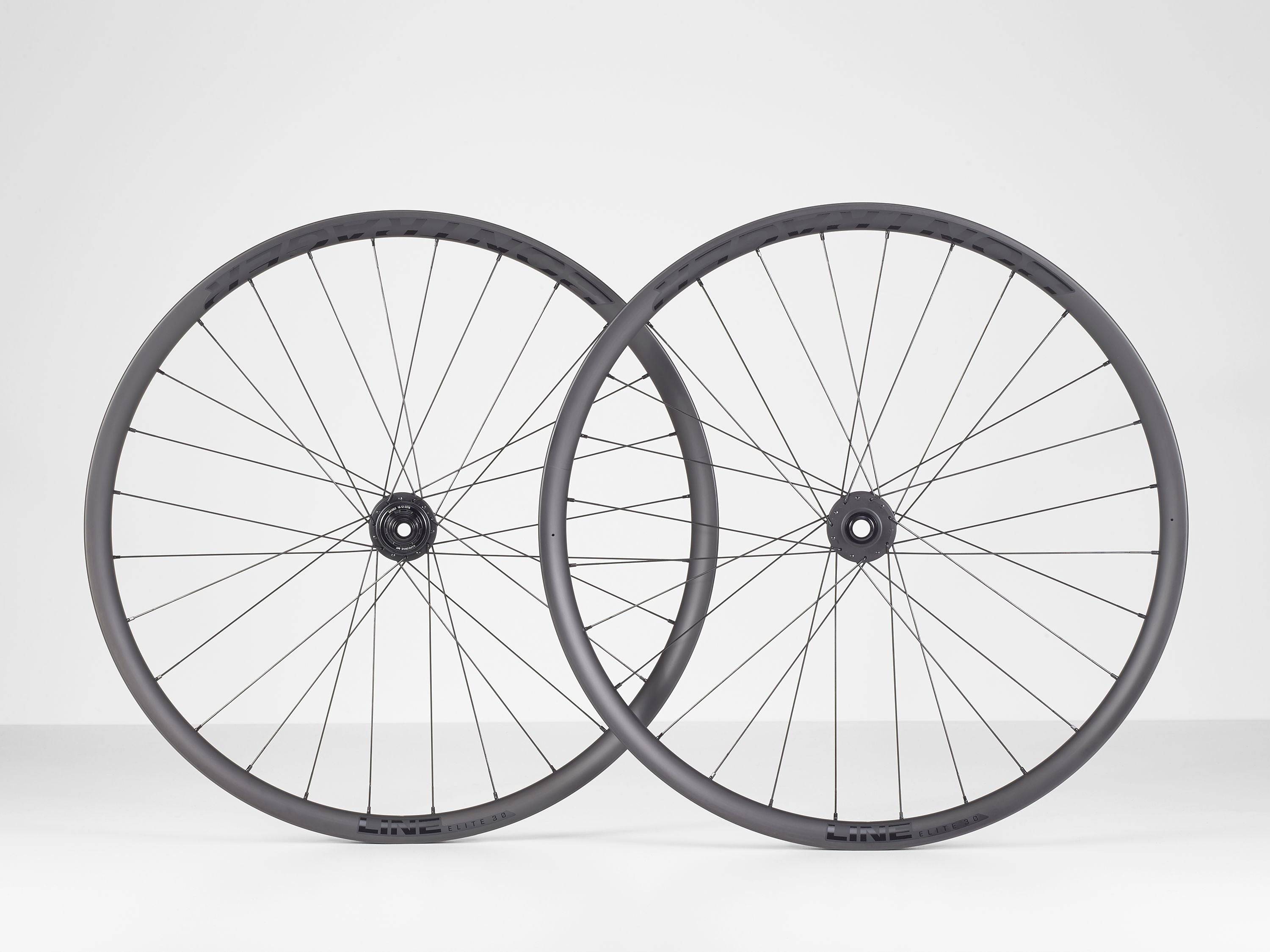 Black Bontrager Line Elite 30 TLR Boost 27.5 MTB front wheel with tubeless-ready design and no cassette, durable bike component.