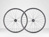 Black Bontrager Line Elite 30 TLR Boost 27.5 MTB front wheel with tubeless-ready design and no cassette, durable bike component.