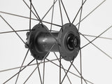 Black Bontrager Line Elite 30 TLR Boost 27.5 MTB front wheel with tubeless rim and spokes, no cassette installed.