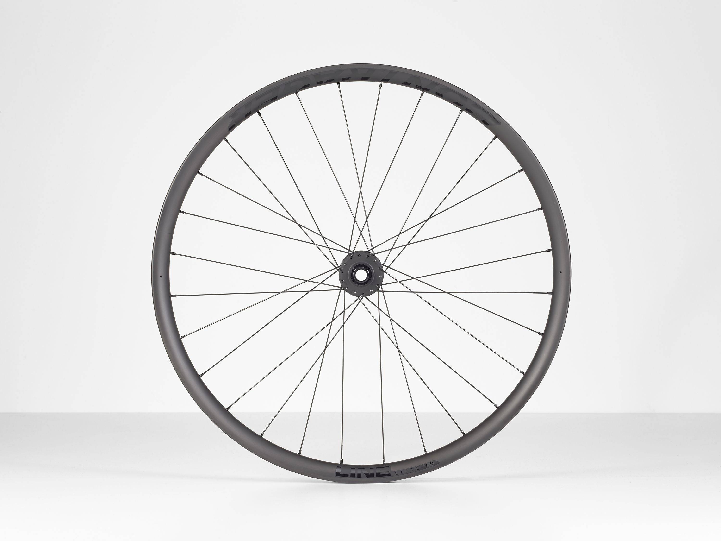 Black Bontrager Line Elite 30 TLR Boost 27.5 MTB front wheel with tubeless-ready rim and boost hub for mountain biking.