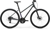 Gray Merida Crossway 10 women's hybrid bike with Shimano 7-speed gears and disc brakes, featuring a lightweight frame.