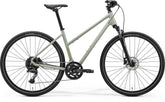 Merida Crossway 300 Women's hybrid bike with suspension fork and Shimano disc brakes, featured in gray and green.