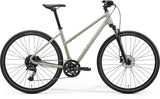 Merida Crossway 300 Women's hybrid bike with suspension fork and Shimano disc brakes, featured in gray and green.