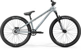 Merida Dirt 700 MY26 kids dirt jump bike with RockShox Pike DJ fork and SRAM brakes, blue frame, ready for mountain trails.