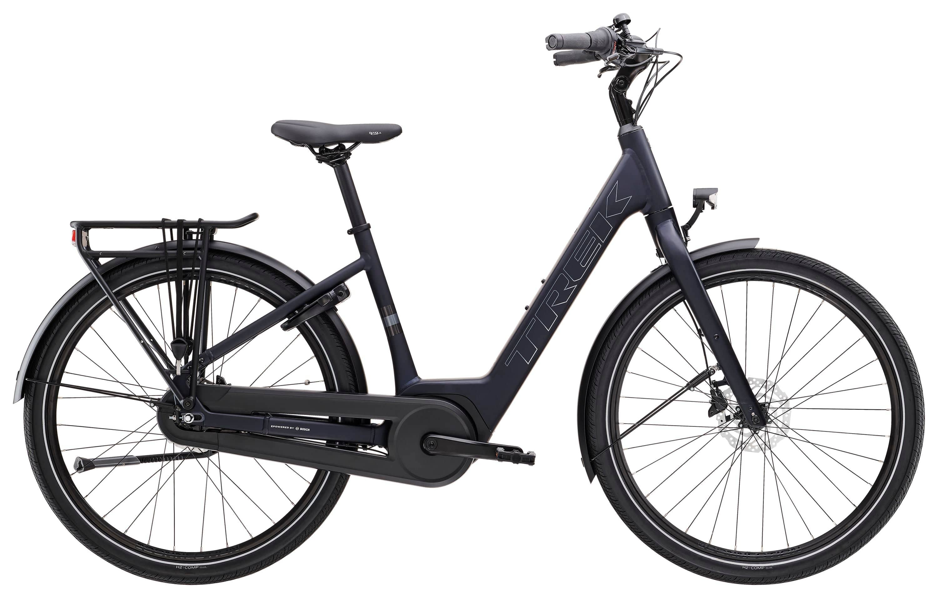 Trek District+ 1 Lowstep women's 2025 e-hybrid bike for urban commuting, shown in a city street setting.