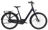 Trek District+ 1 Lowstep women's 2025 e-hybrid bike for urban commuting, shown in a city street setting.
