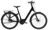 Trek District+ 2 lowstep women's e-hybrid bike for urban commuting with black frame, comfortable saddle, and integrated lighting.