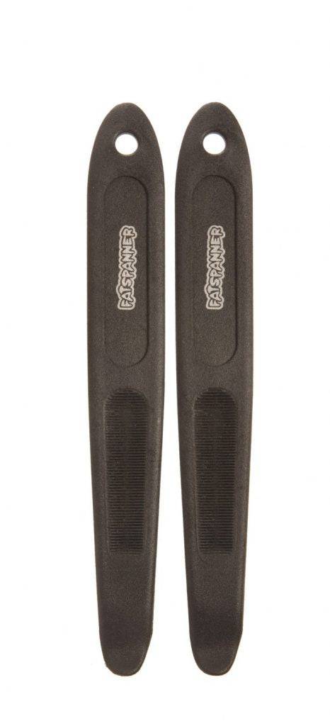 Pair of Fat Spanner long tyre levers with durable wide design for bike repairs, shown on a workshop surface.