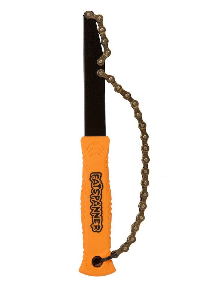 Fat Spanner Chainwip tool for 10-speed cassette maintenance, shown in workshop setting with tool and bike components.