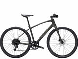 Trek FX Sport 5 hybrid bike with carbon frame, SRAM Apex drivetrain, and hydraulic disc brakes on smooth road.