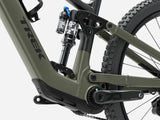 Trek Fuel+ EX 8 Gen 2 e-mountain bike outdoors, showing its frame and suspension for versatile trail riding.