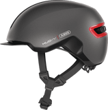 ABUS HUD-Y urban cycling helmet with rechargeable rear LED light, side view showing sleek design and safety features.