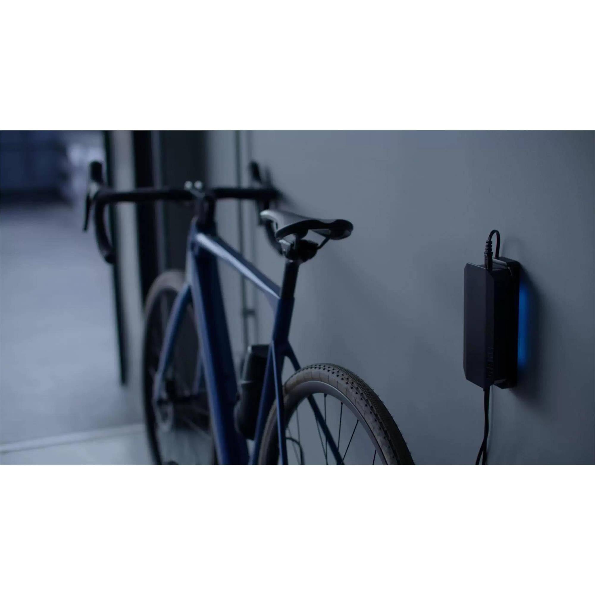MAHLE X Active Charger with wall mount for X20 and X30 e-bike systems, showing the compact charging unit and mounting hardware.