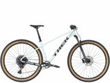 Trek Marlin 7 Gen 3 mountain bike with black frame and knobby tires, suited for trail riding and outdoor adventure.