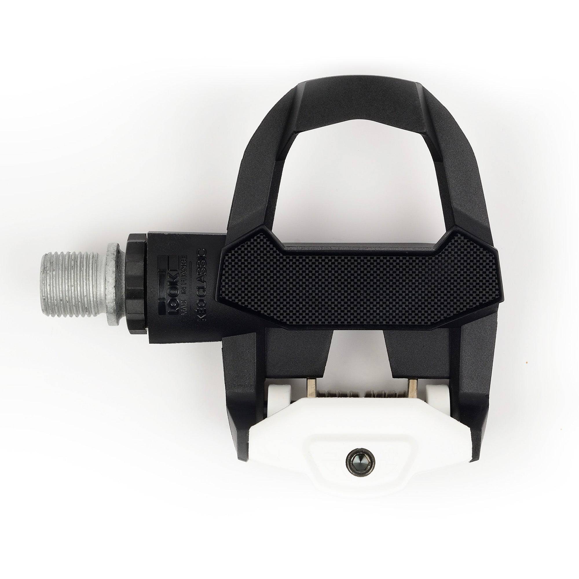 Look Keo Classic 3 road bike pedals with Keo Grip cleats in black and white, showcasing their sleek design and pedal mechanism.