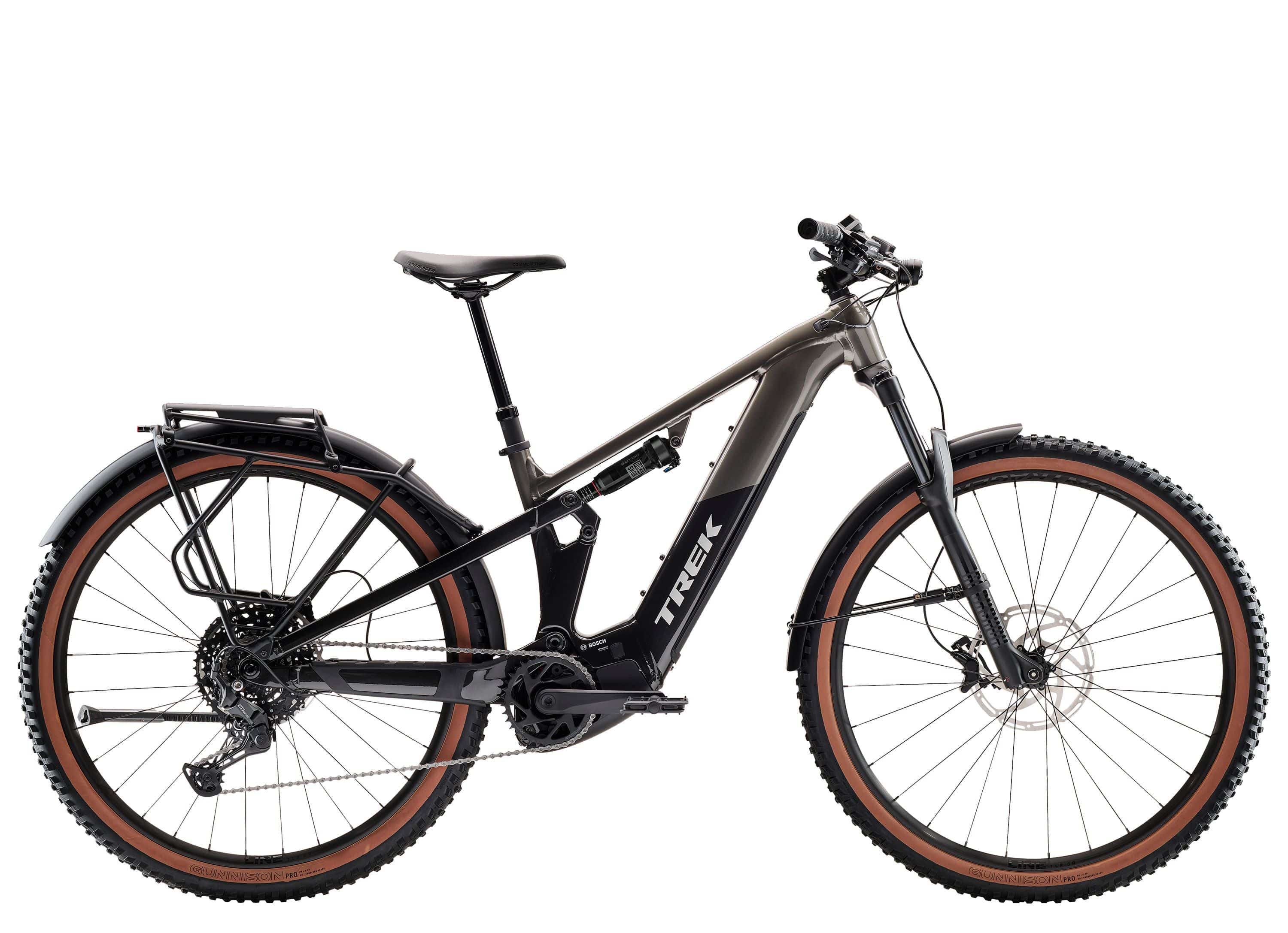 Trek Powerfly FS+ 4 mountain bike with full suspension and 800Wh removable battery, shown in a rugged outdoor setting.