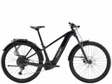 Trek Powerfly+ 4 EQ electric mountain bike with 29-inch wheels and Gen 5 motor, shown in a natural outdoor setting.
