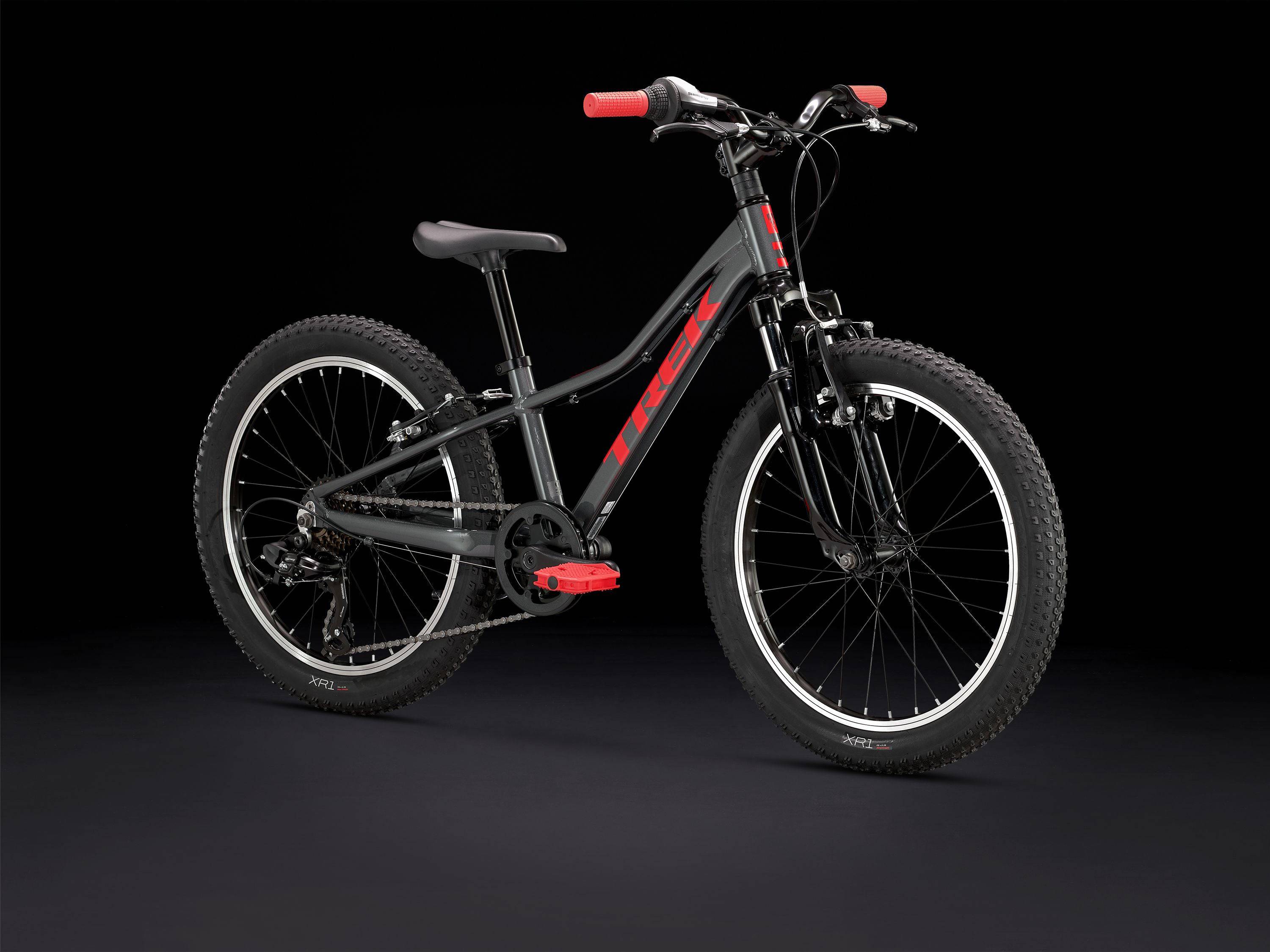 Trek Precaliber 20 kids mountain bike with 7-speed gearing, parent handle, and durable frame for learning and trail riding.
