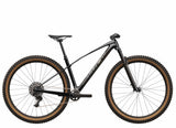 Trek Procaliber 9.6 Gen 3 mountain bike with IsoBow frame for trail riding, featuring a sleek black frame and rugged tires.