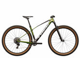 Trek Procaliber 9.6 Gen 3 mountain bike with IsoBow frame technology for trail riding, black and orange color, view from side