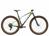 Trek Procaliber 9.6 Gen 3 mountain bike with IsoBow frame technology for trail riding, black and orange color, view from side