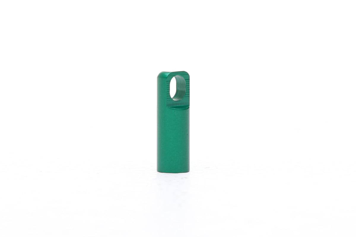 Green Fatty's Valve Dustcap with integrated valve removal tool for easy tire maintenance, shown on a workshop setting.