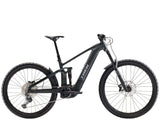Trek Rail+ 5 Gen 5 electric mountain bike with 29-inch wheels and Shimano Deore M6100 gears, black frame, and suspension.