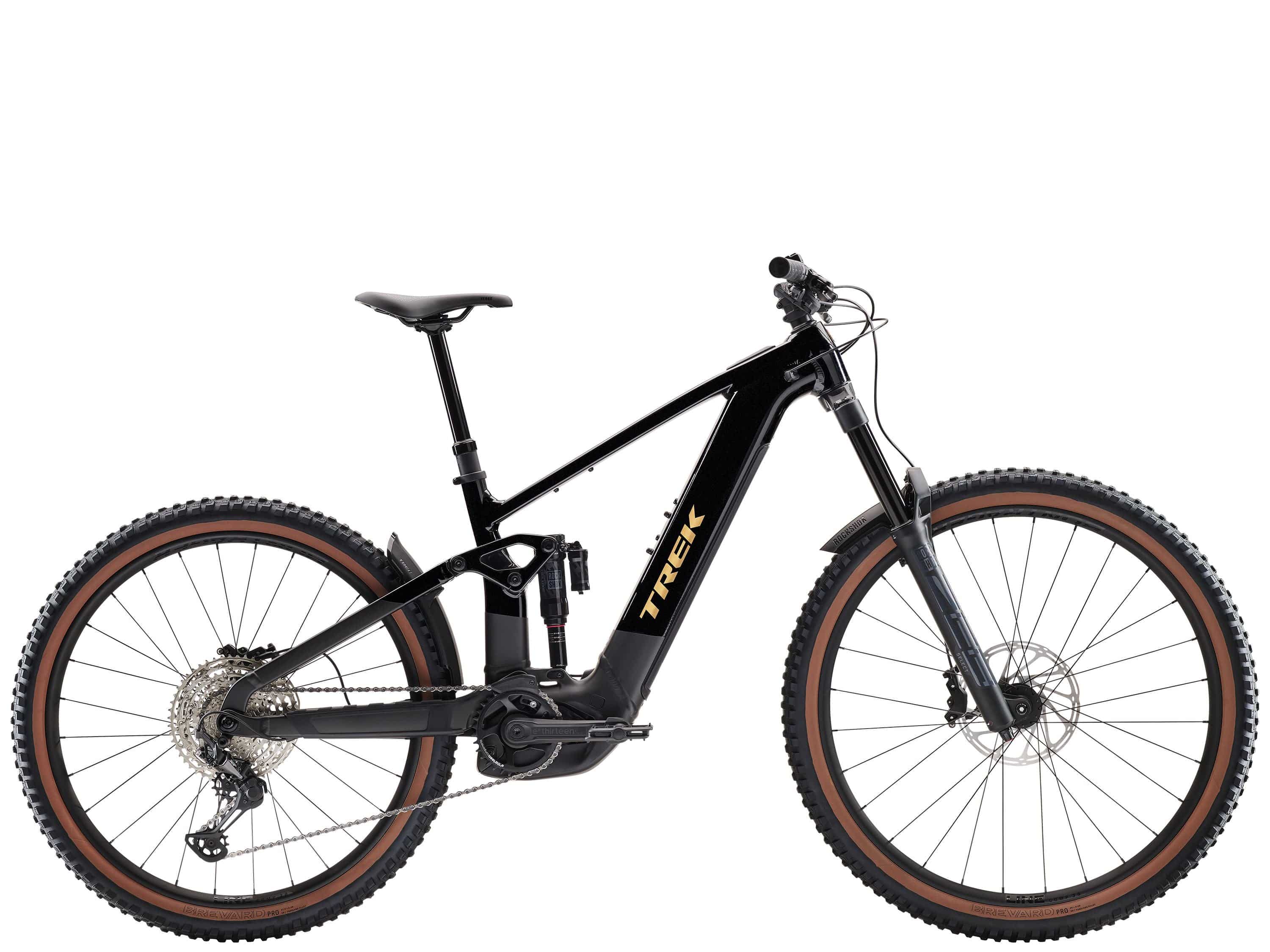 Trek Rail+ 8 electric mountain bike featuring a sleek frame, Shimano Deore XT groupset, and Gen 5 motor in a scenic outdoor setting.