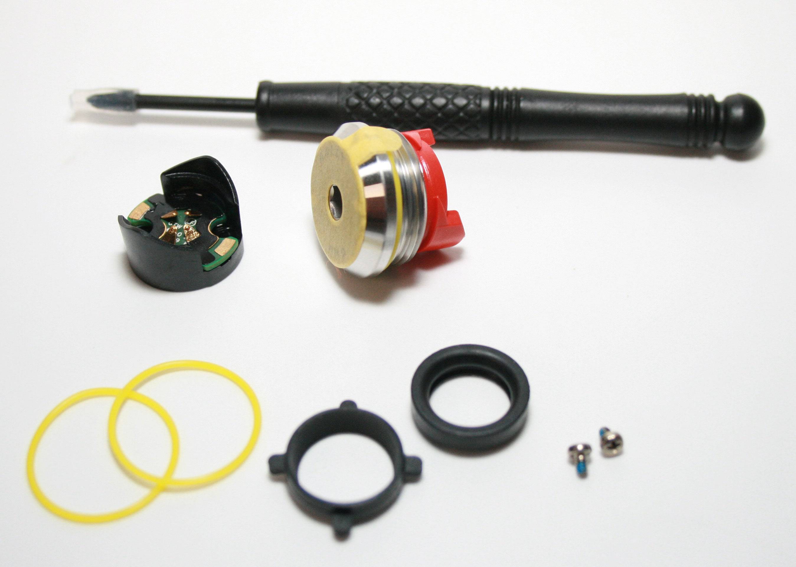 Garmin Rally Rs/Rk battery door kit replacement component, showing the spare battery door for Garmin sports watch or device.